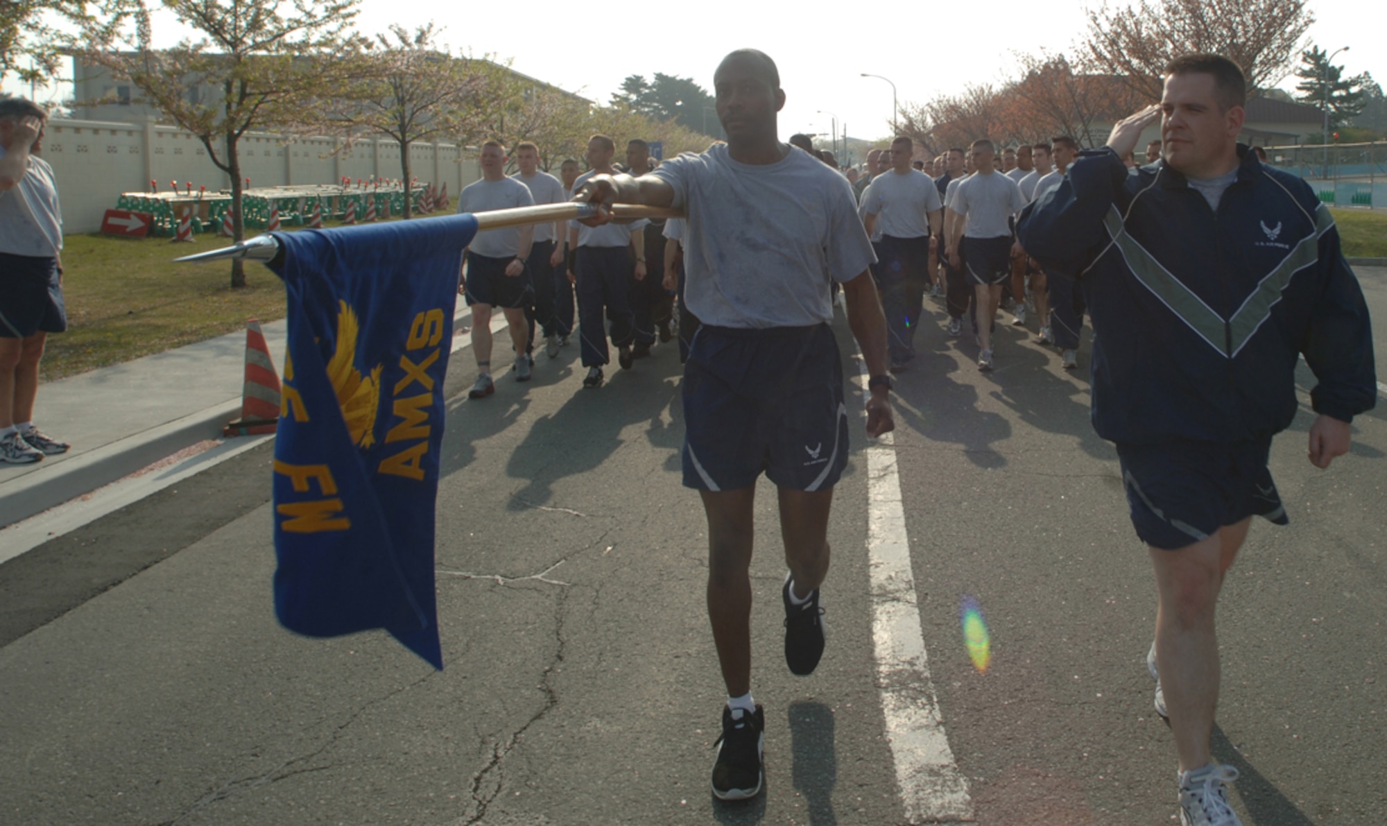 MISAWA AIR BASE, Japan -- Members of the 35th Aircraft Maintenance Squadron execute a pass and review in front of base leadership during a readiness run here May 2, 2008.  This month's readiness run helped to kick-off National Physical Fitness and Sports Month. (U.S. Air Force photo by Senior Airman Robert Barnett)