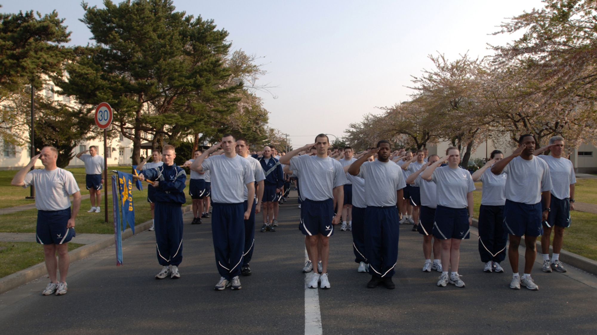 MISAWA AIR BASE, Japan -- Airmen in formation salute during the playing of the National Anthem prior to a readiness run May 2, 2008.  Air Force, Army, Navy and Japan Air Self Defense Force members from Misawa Air Base all took part in the first readiness run of the year.  (U.S. Air Force photo by Senior Airman Robert Barnett)
