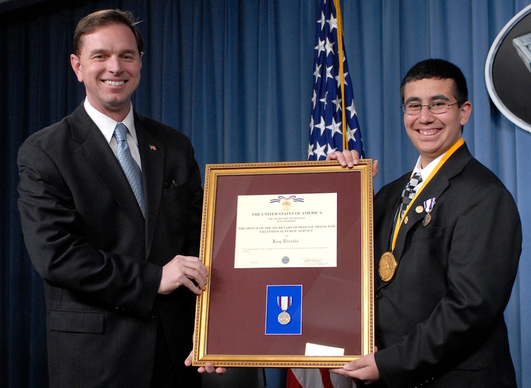 Principal Deputy Assistant Secretary of Defense for Public Affairs Robert T. Hastings, left, presents the certificate for the Office of the Secretary of Defense Medal for Exceptional Public Service to Joey Rizzolo, a seventh grader from Paramus, N.J., at the Pentagon, May 6, 2008. Rizzolo was awarded the medal for his support of Americas's servicemembers and his ASY Freedom Walk contributions. Defense Department photo by U.S. Navy Petty Officer 2nd Class Molly A. Burgess