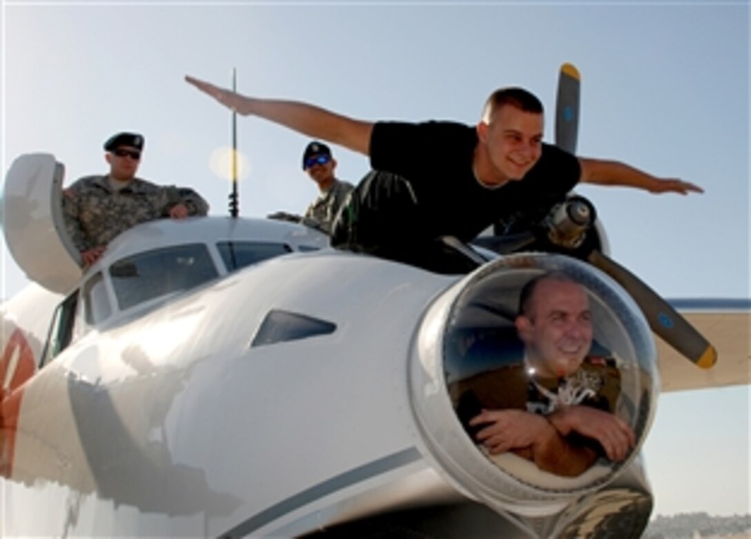 Wounded soldiers assigned to the Warrior Transition Company on Naval Medical Center, San Diego, enjoy a moment of levity as they pose for a photo with the Red Bull Albatross seaplane after enjoying a VIP flight aboard the craft, May 2, 2008. 