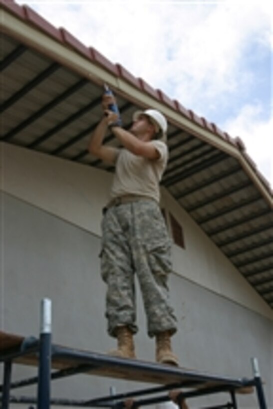 A U.S. Army soldier from 84th Engineer Combat Battalion caulks a roof edge to give a smoother-looking appearance to Engineering Civic Action Project Site 5 in Buriram Province, Thailand, during exercise Cobra Gold on May 1, 2008.   The exercise provides constructive benefits in the form of a multi-purpose school building for Thai children through combined U.S.-Thai civil affairs projects.  