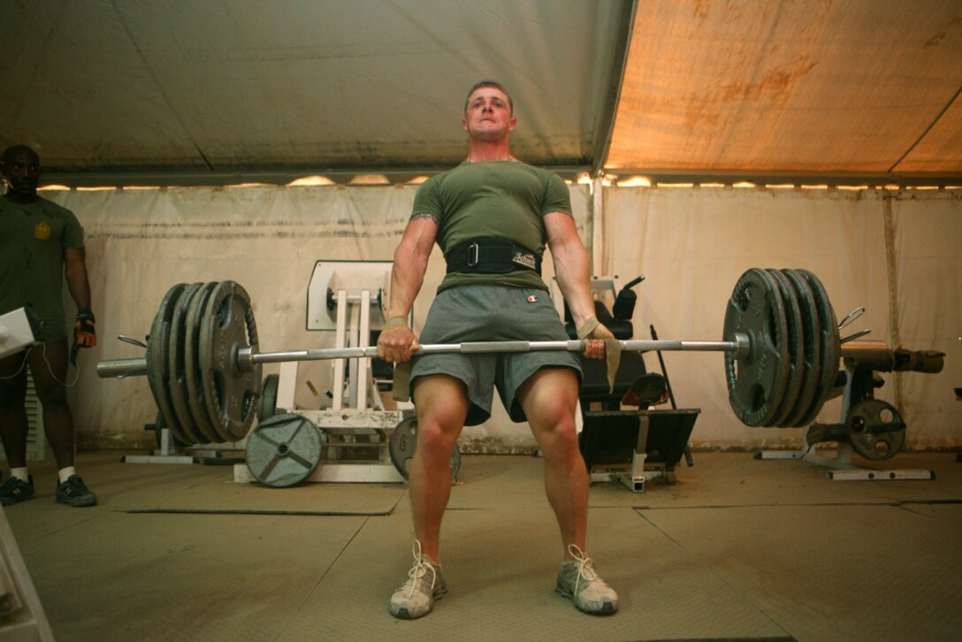 Lance Cpl. Christopher J. Talbot, a scout with Charlie Company, 2nd Light Armored Reconnaissance Battalion, Regimental Combat Team 5, dead-lifts 475 pounds during a daily work out at Camp Korean Village, Iraq, May 6. The native of Torrington, Conn., began working out at age 10 when his mom decided to attend aerobics classes at the local YMCA. While his mother was engaged in her workouts, he took the opportunity to achieve what would become his life long goal: becoming a professional body builder.