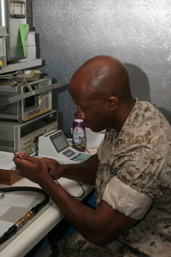 Staff Sgt. Herman Miller, a calibration chief with MWCS-28, tests equipment.