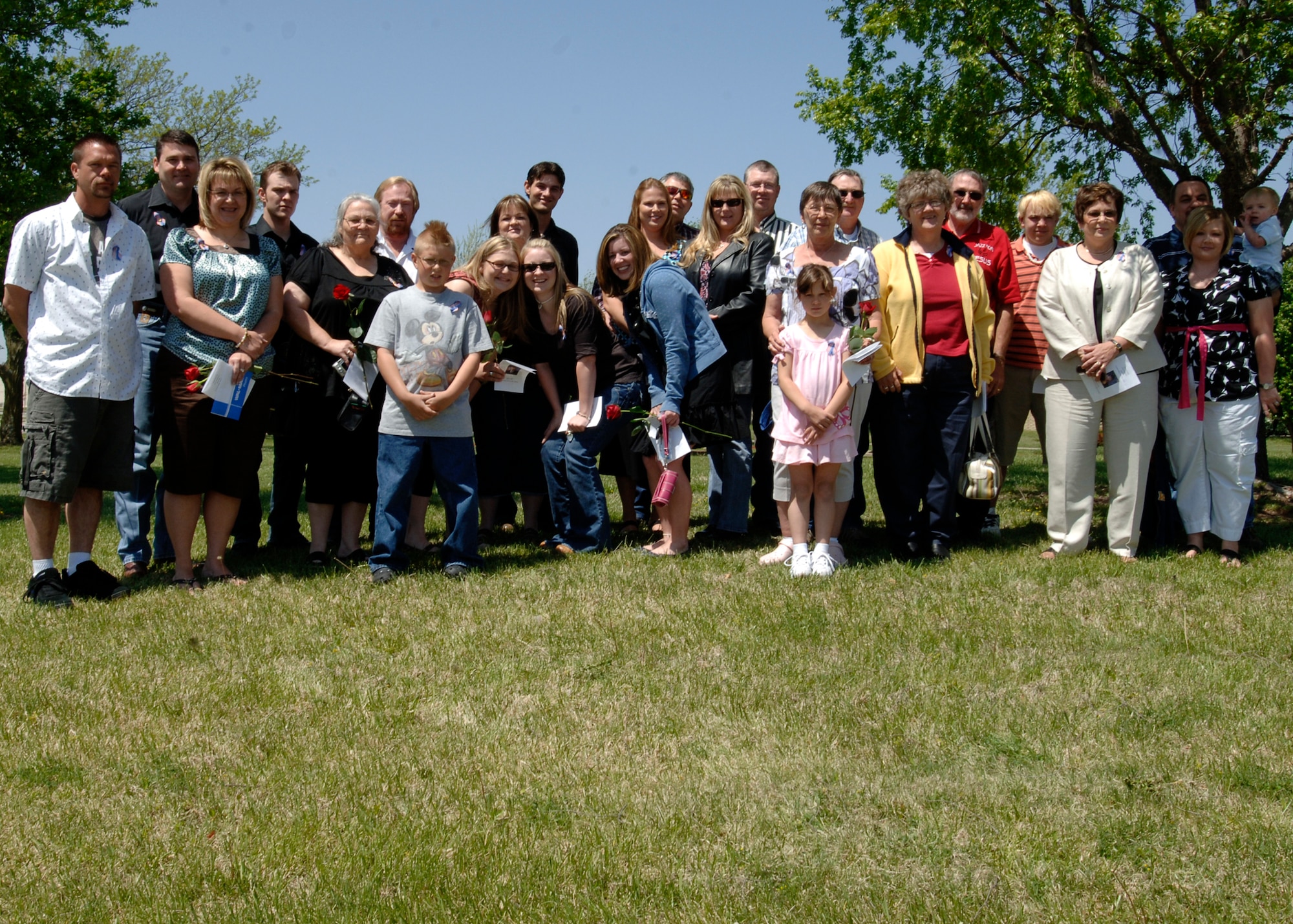 MCCONNELL AIR FORCE BASE, Kan. -- Family members of the late Senior Airman Jonathan Blake Perry, 22nd Aircraft Maintenance Squadron, communication and navigation systems specialist, gather for a family photo on his behalf at the Memorial Walk, May 4. More than 20 of Airman Perry’s family members attended the memorial service. (Photo by Airman Justin Shelton)
