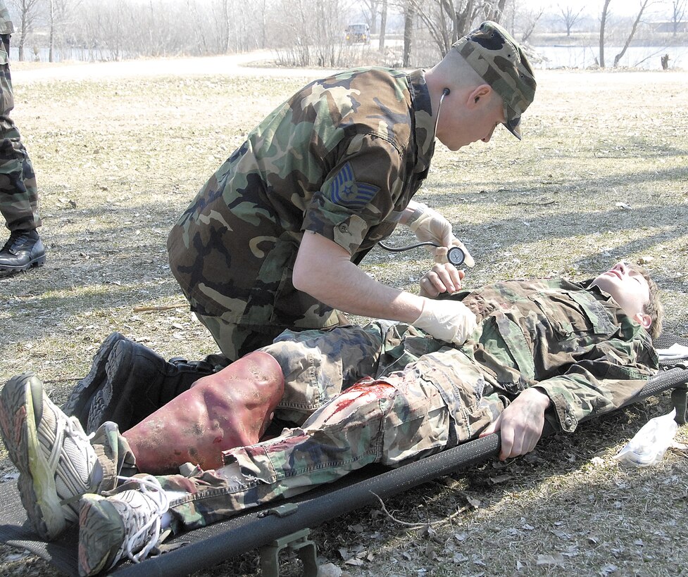 Air Force reservist Tech. Sgt. Eric Anderson, a medical service technician, attends to a wounded "victim" during the 710th Medical Squadron's field training exercise at Offutt Air Force Base, Neb. The 710th is an Air Force Reserve Command squadron based at Offutt and is a geographically separated unit assigned to the 442nd Fighter Wing at Whiteman AFB, Mo. (US Air Force photo/Tech. Sgt. John Vertreese)