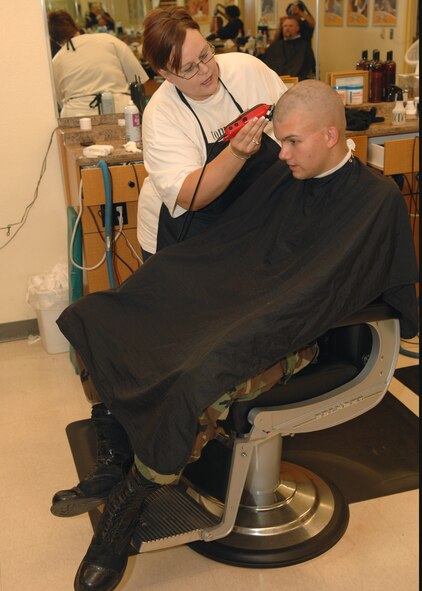 DYESS AIR FORCE BASE, Texas -- Airman 1st Class Micheal Breaux,7th Bomb Wing, gets his haircut from Shayla Billeter at the Base Exchange barber shop May 7. The BX barber shop is open everyday for all service members and their families. (U.S. Air Force Photo by Airman 1st Class Stephen Reyes)