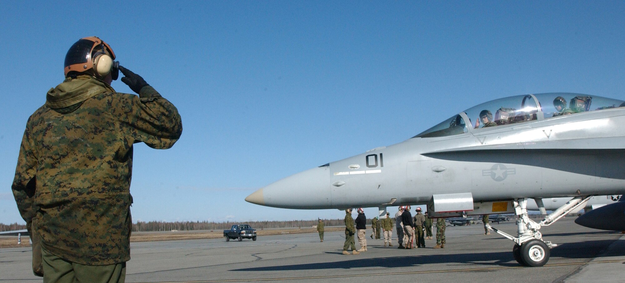 EIELSON AIR FORCE BASE, Alaska --  Lance Cpl. Alantheus Thompson, a plane captain with Marine Attack Squadron 242,  gives the final salute before launching an F/A-18 on a training mission during Northern Edge ?08 at Eielson AFB in Fairbanks, Alaska. VMFA (AW) 242 traveled from Iwakuni, Japan to participate in the two-week joint training exercise. (U.S. Marine Corps photo by Sgt. Rocky Smith)                     