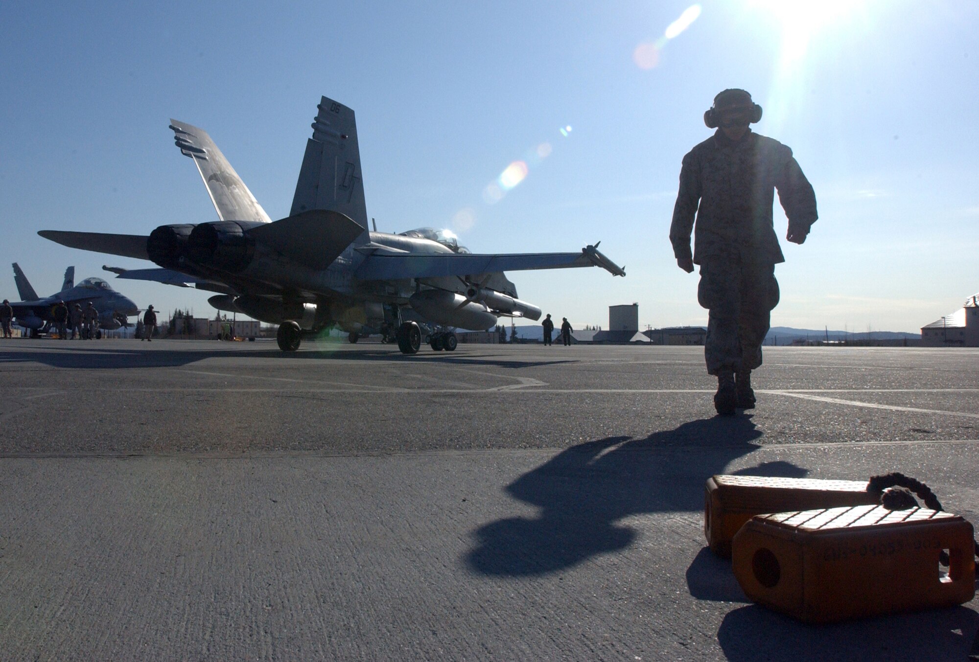 EIELSON AIR FORCE BASE, Alaska --  Lance Cpl. Joseph Trent, a plane captain with Marine Attack Squadron 242, walks away after launching an F/A-18 on a training mission during Northern Edge ?08 at Eielson AFB in Fairbanks, Alaska. VMFA (AW) 242 traveled from Iwakuni, Japan to participate in the two-week joint training exercise. (U.S. Marine Corps photo by Marine Sgt. Rocky Smith)                                