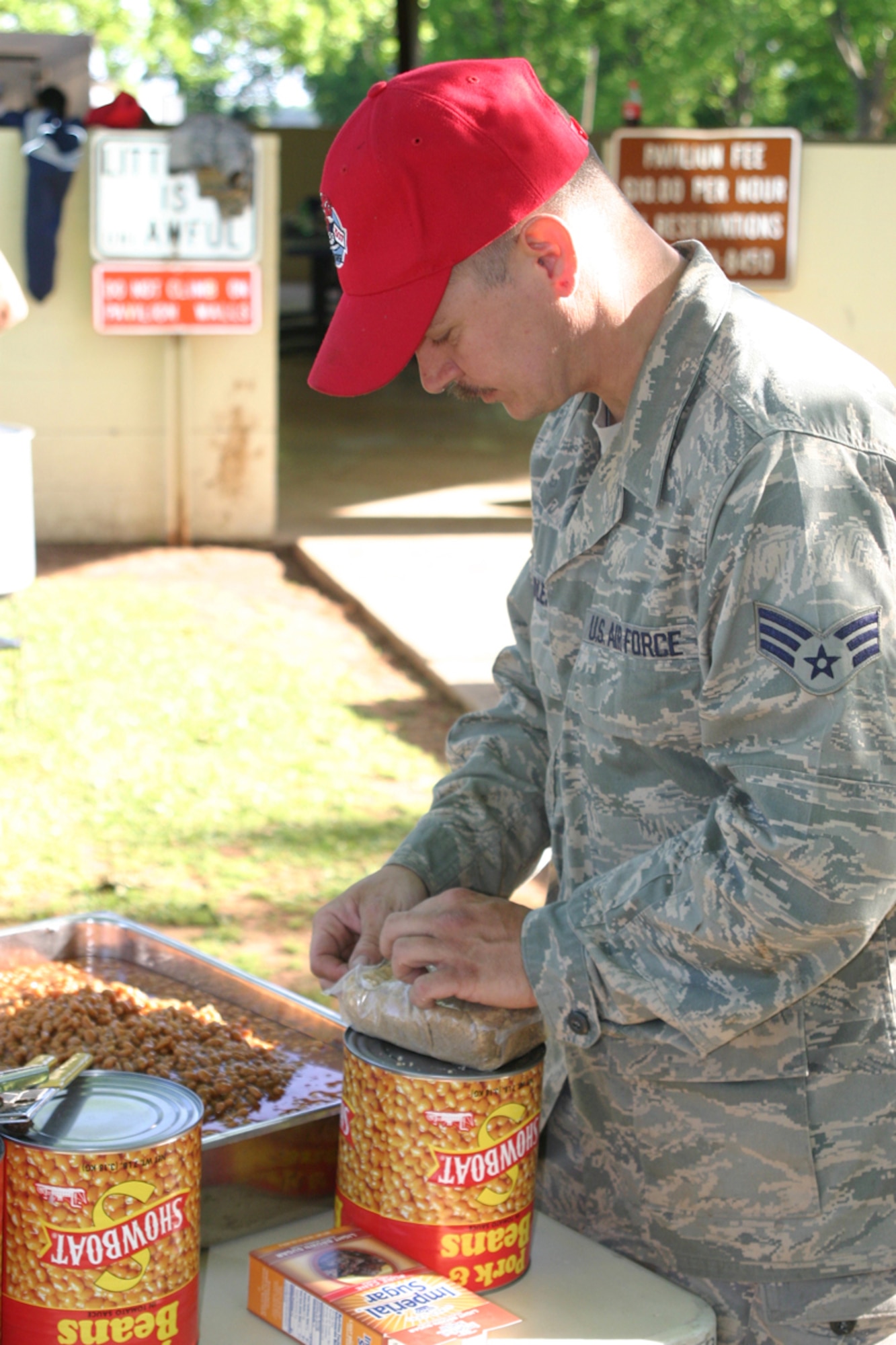 Senior Airman Mark L. Huddleston, 307th Red Horse Squardron, pavement and equipment operator, helps prepare lunch during a welcome home celebration for members of the 307 RHS returning from duty in Iraq. Over 300 friends and family attended the event at Mike Woods Park, Saturday, May 3, 2008. (US Air Force photo/Tech. Sgt. Jeffrey S. Walston)