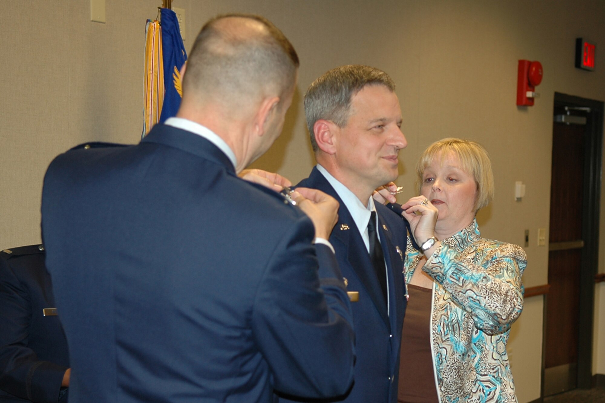 Col. Ozzie H. Gorbitz, commander, 917th Operations Group, and Lisa Teauseau, wife, pin the rank of Colonel on Col. Alan C. Teauseau, commander, 93rd Bomb Squadron, during his promotion ceremony at the 93 BS operations building, Saturdday, May 3, 2008. (US Air Force photo/Tech. Sgt. Jeffrey S. Walston)