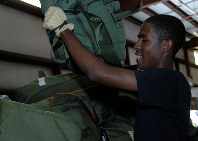 Airman DeAngelo Brundidge sorts bags for Airmen returning to Charleston Air Force base May 6 from a mobility exercise.  The MOBEX was held in Alpena, Mich., this week to evaluate the base?s readiness in preparation for an operational readiness inspection in August. Airman Brundidge is a war readiness technician with the 437th Logistics Readiness Squadron (U.S. Air Force photo/Airman 1st Class Katie Gieratz)