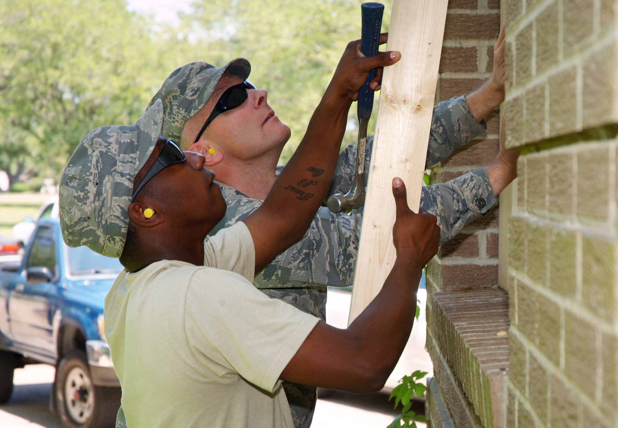 Last week’s hurricane exercise tested Keesler’s ability to prepare for a storm and evacuate the base if necessary.  Staff Sgt. Chris Shivers, left, and Tech. Sgt. Callen Cavinder, 81st CS, board up the building’s windows.  (U.S. Air Force photo by Adam Bond)