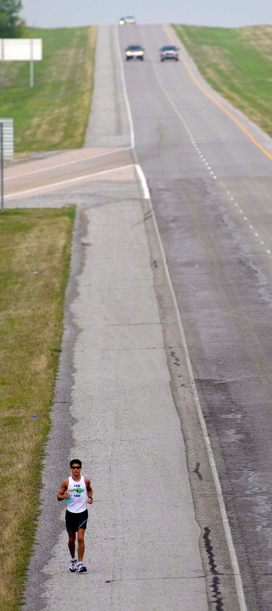 Senior Airman Brendan Brustad makes his way eastward April 24 on U.S. Highway 62 on day two of his 168-mile run in honor of the victims of the April 19, 1995, bombing of the Alfred P. Murrah Federal Building in Oklahoma City. Airman Brustad is a medical material journeyman at Altus Air Force Base, Okla. (Courtesy photo) 
