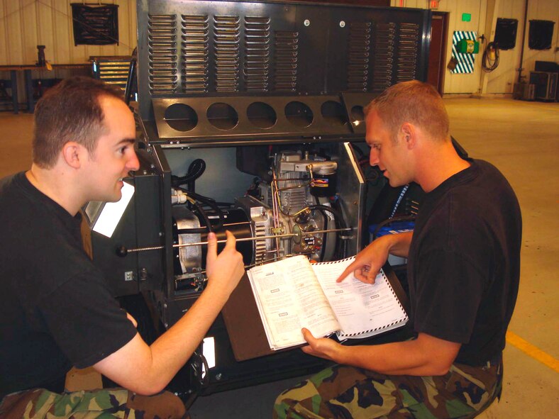 TRAVIS AIR FORCE BASE, Calif. -- Tech Sgt. Larry Dubuque and Tech Sgt. Jesse Lawless, Aerospace Ground Equipment Craftsmen, demonstrate proper use of technical data during the April B-Flight UTA. (U.S. Air Force photo/Staff Sgt. Meredith Mingledorff)