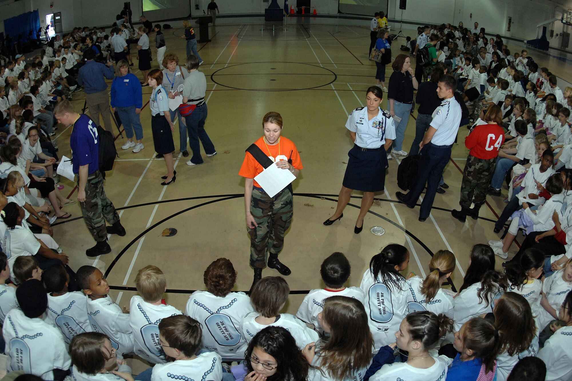Airman 1st Class Cheryl Hom (orange shirt), an imagery analyst from the 20th Intelligence Squadron, briefs her group of students as they prepare to process through a mobility line. (U.S. Air Force Photo By/Josh Plueger) 