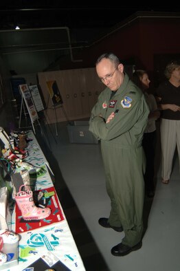 Lt. Col. Robert Maness, 55th Wing vice commander, judges displays entered into the Sexual Assault and Response Office's shoe decorating contest. Members of Team Offutt decorated shoes to help raise awareness for child abuse and sexual assault. Colonel Maness judged entries in both single and team categories. The shoe decorating contest was held in conjunction with a “Can you walk in her shoes” event and a 5K run at the Offutt Field House on April 18. April was Sexual Assault Awareness Month. (U.S. Air Force Photo By/Tech. Sgt. Rhonda Moraski)