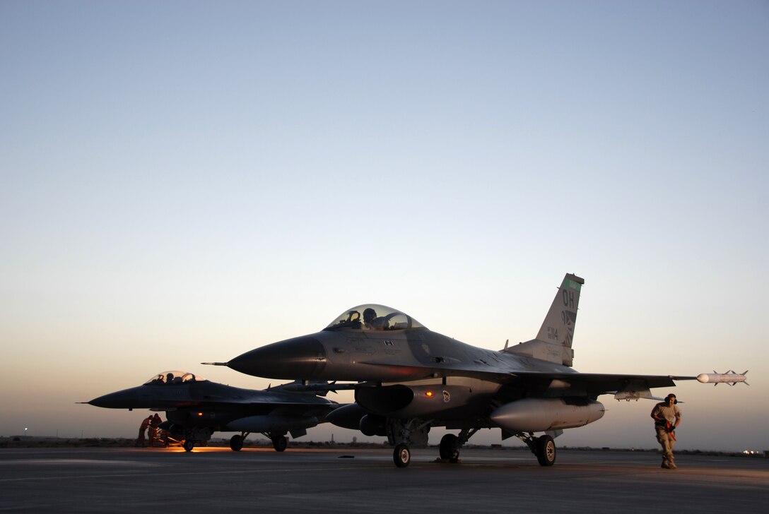 332nd Expeditionary Operations Group Commander, Col. Scott Dennis and LtCol Rob Webb wait at the End of the Runway (EOR) while weapons loader, TSgt Mike Przyiecki "safes" the F-16's munitions after a combat sortie at Balad Air Base, Iraq. USAF Photo by TSgt Beth Holliker (Released).