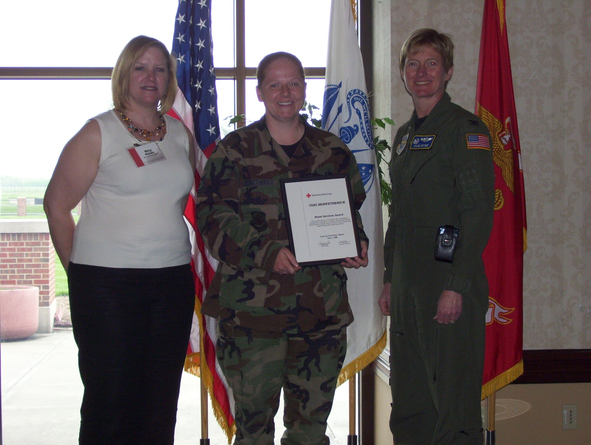 SCOTT AIR FORCE BASE, Ill. --Tech. Sgt. Teri Beswetherick, Air Mobility Command logistics directorate, was honored last week by the American Red Cross with their Blood Services Award for her volunteer work. Sergeant Beswetherick donates her time to the monthly blood drives on base and tends to the needs of the donors making sure they are comfortable. In addition to being a donor herself, Sergeant Beswetherick has contributed to the successful collection of more than 550 useable units of blood. Sergeant Beswetherick (center) is pictured with 375th Medical Group Commander Col. Dianne Ritter and Red Cross director of volunteer resources Mary Rosen. (U.S. Air Force photo/Mr. Monte miller)