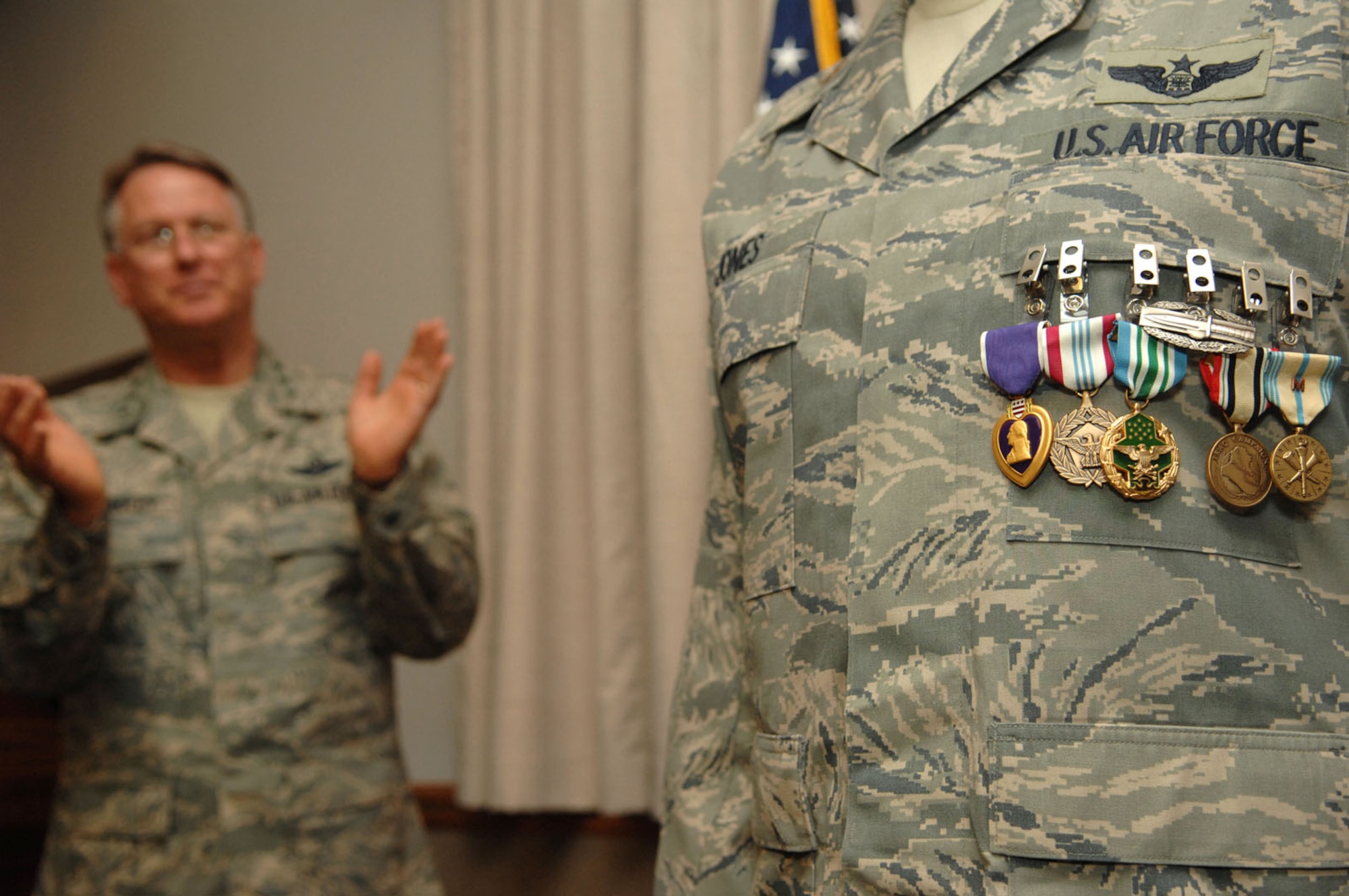 NELLIS AIR FORCE BASE, Nev. -- Lt. Gen. John Bradley, Air Force Reserve Command commander, congratulates Maj. Anthony Jones, 99th Air Base Wing chief of exercise plans and programs, during a ceremony at the Officers Club here Monday. Major Jones was awarded six decorations for his heroic actions while deployed to Camp Victory, Iraq. (U.S. Air Force Photo by/Senior Airman Larry E. Reid Jr.)
