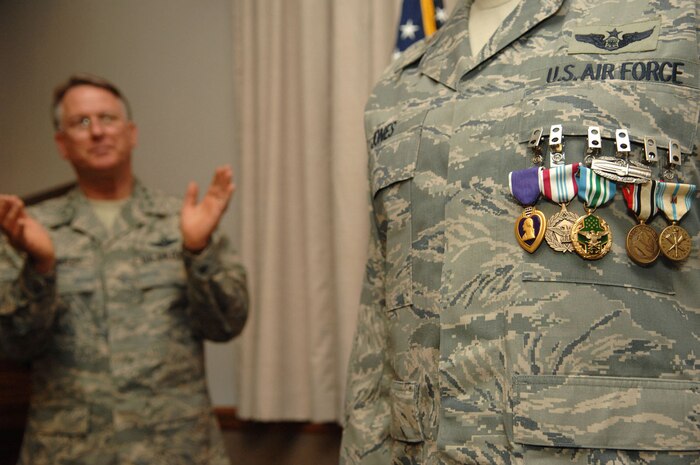 NELLIS AIR FORCE BASE, Nev. -- Lt. Gen. John Bradley, Air Force Reserve Command commander, congratulates Maj. Anthony Jones, 99th Air Base Wing chief of exercise plans and programs, during a ceremony at the Officers Club here Monday. Major Jones was awarded six decorations for his heroic actions while deployed to Camp Victory, Iraq. (U.S. Air Force Photo by/Senior Airman Larry E. Reid Jr.)
