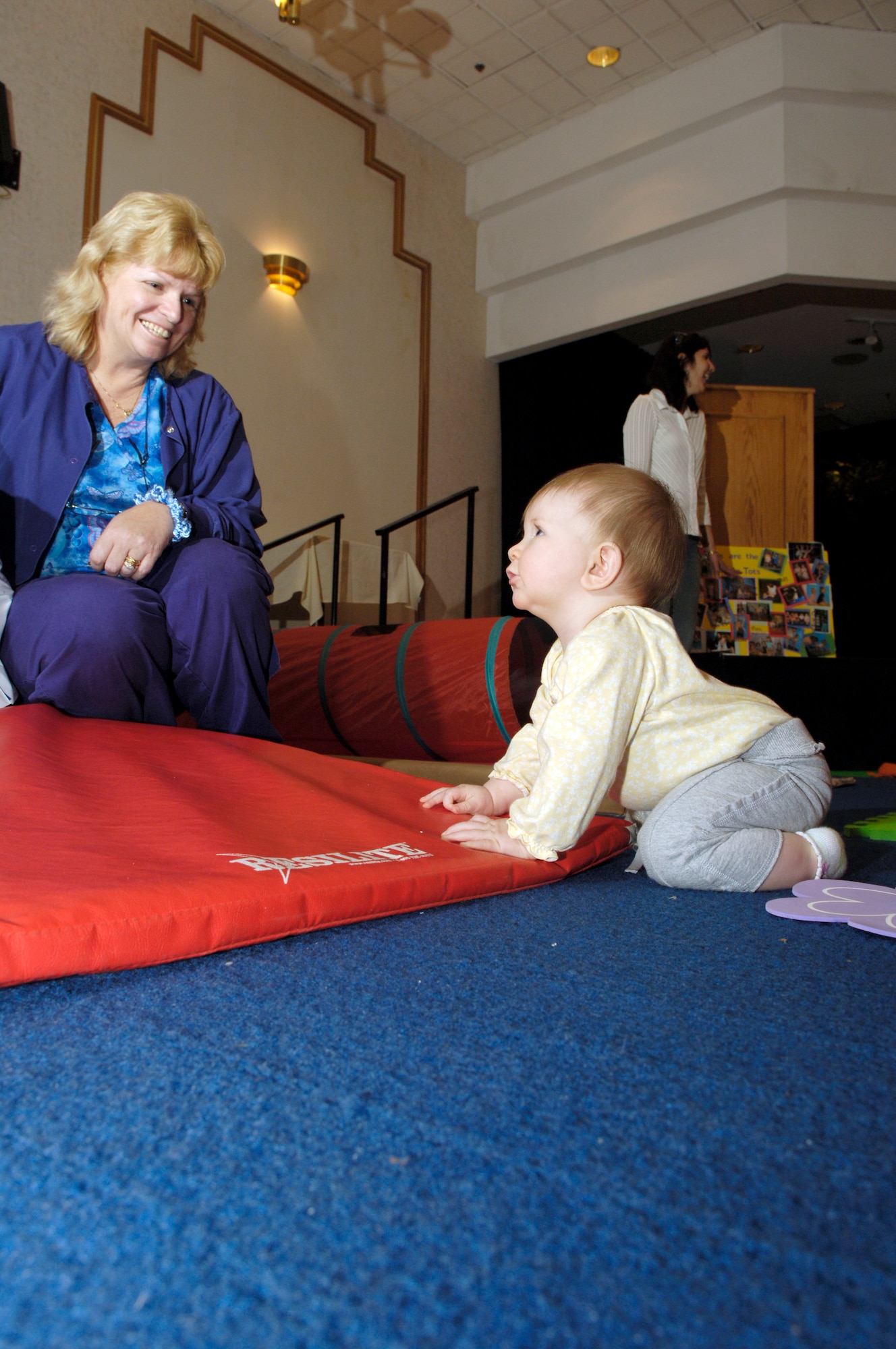 April Kassel plays with her granddaughter, 8-month-old Olivia Jenning, during the Baby & Toddler Expo May 2 at The Club here. More than 30 vendors participated in the expo to provide support to military families and highlight the programs and products available for children. (U.S. Air Force photo/Kenn Mann) 

