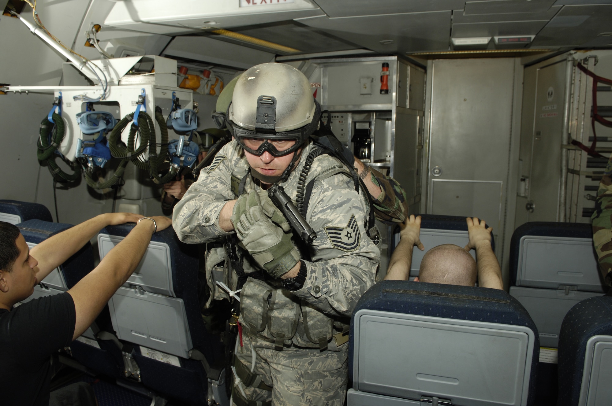 During aircraft interdiction training, Tech. Sgt. Thomas Tully, 817th Contingency Response Group, searches and clears the interior of a KC-10A Extender recently at McGuire Air Force Base, N.J. The training prepared McGuire and Fort Dix security team members to resolve high-risk incidents involving hijacked aircraft. (U.S. Air Force photo/Kenn Mann)