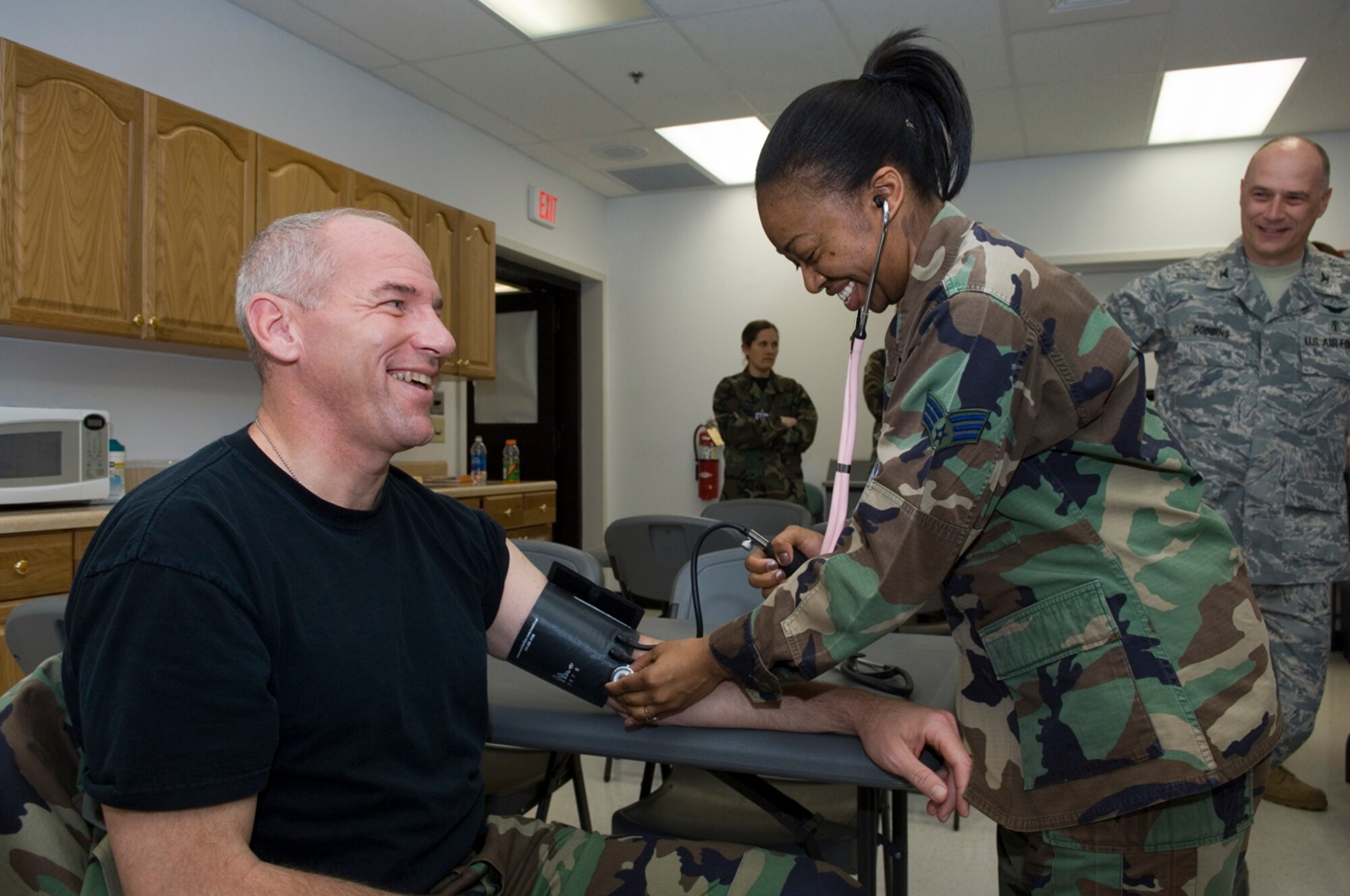 HANSCOM AFB, Mass. - Col. Tom Schluckebier (left), 66th Air Base Wing commander, gets his blood pressure checked by Senior Airman Nikolia Saunders (right), Family Practice Clinic nurse. Colonel Schluckebier joined 66th Medical Group nurses and technicians on May 6 in celebrating, National RN Recognition Day and National Nurses, Technicians week, which takes place annually May 6 to12. 

Colonel Schluckebier honored the dedication, commitment, and tireless effort of the nurses and technicians at the 66 MDG and signed a proclamation declaring May 6 to 12, National Nurses and Technicians week here at Hanscom.  (U.S. Air Force Photo by Rick Berry)
