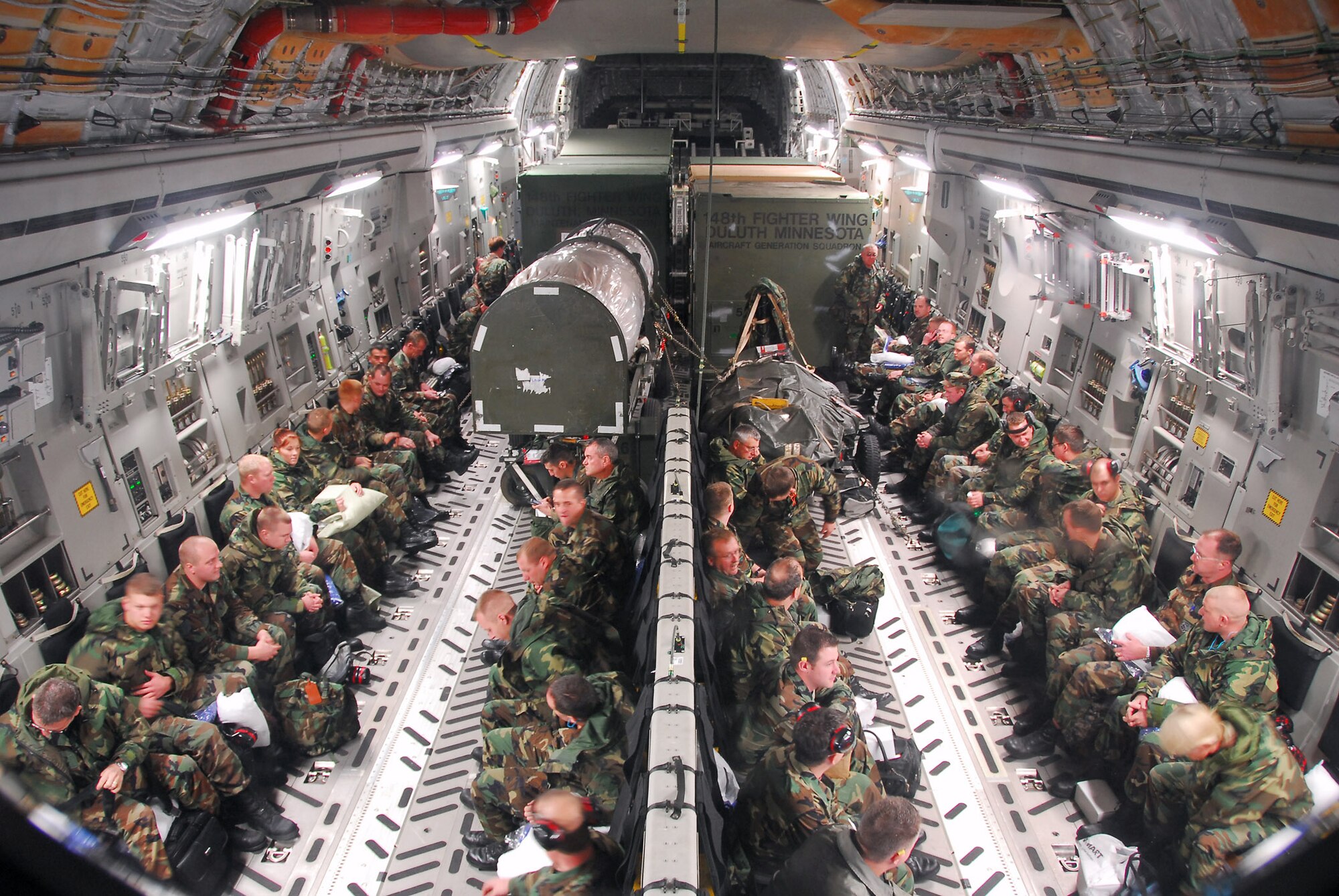 Minnesota Air National Guard members of the 148th Fighter Wing await departure in a C-17 Globemaster prior to departing to Hickam Air Force Base, Hawaii, Nov. 9, 2007, at the Air National Guard Base located in Duluth, Minn. The 148th FW was selected by Occupational Health and Safety Administration officials for the Voluntary Protection Program Star Award. (U.S. Air Force photo/Tech. Sgt. Jason W. Rolfe)