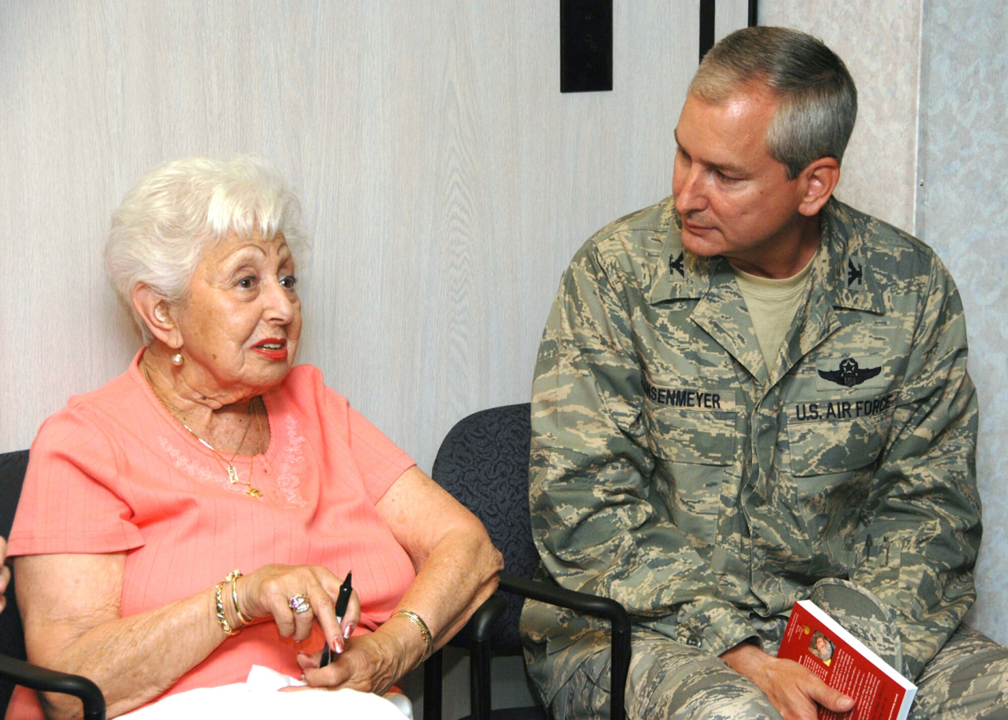 SEYMOUR JOHNSON AIR FORCE BASE, N.C. -- Frieda Roos-Van Hessen shares stories with Col. Fritz Linsenmeyer, 916th Air Refueling Wing commander, during the May unit training assembly. Ms. Roos-Van Hessen is 93 and a survivor of the Holocaust.  She detailed her life in her book, Life in the Shadow of the Swastika. She was on-base to speak to Airmen as part of the Equal Opportunity Office's outreach program. U.S. Air Force photo/Tech. Sgt. Gillian Albro