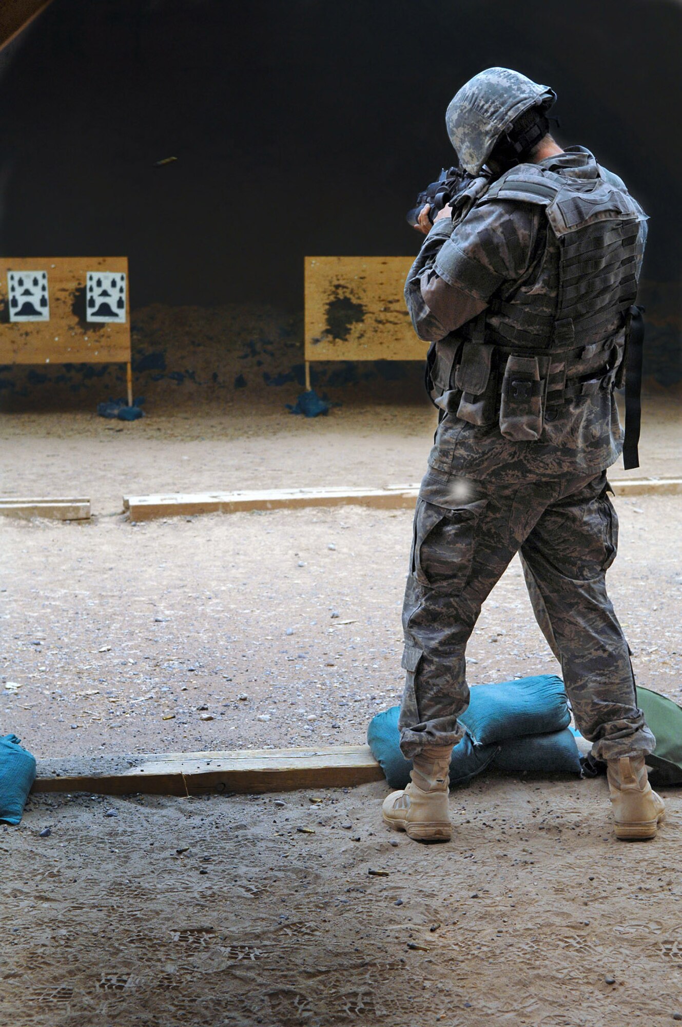 Airman Chad McCambridge shoots an M-4 April 30 at Balad Air Base, Iraq. Security forces members went to the range to zero in their scopes and to get comfortable with their weapons. Airman McCambridge is assigned to the 332nd Expeditionary Security Forces Squadron and deployed from Royal Air Force Lakenheath, England. (U.S. Air Force photo/Senior Airman Julianne Showalter) 
