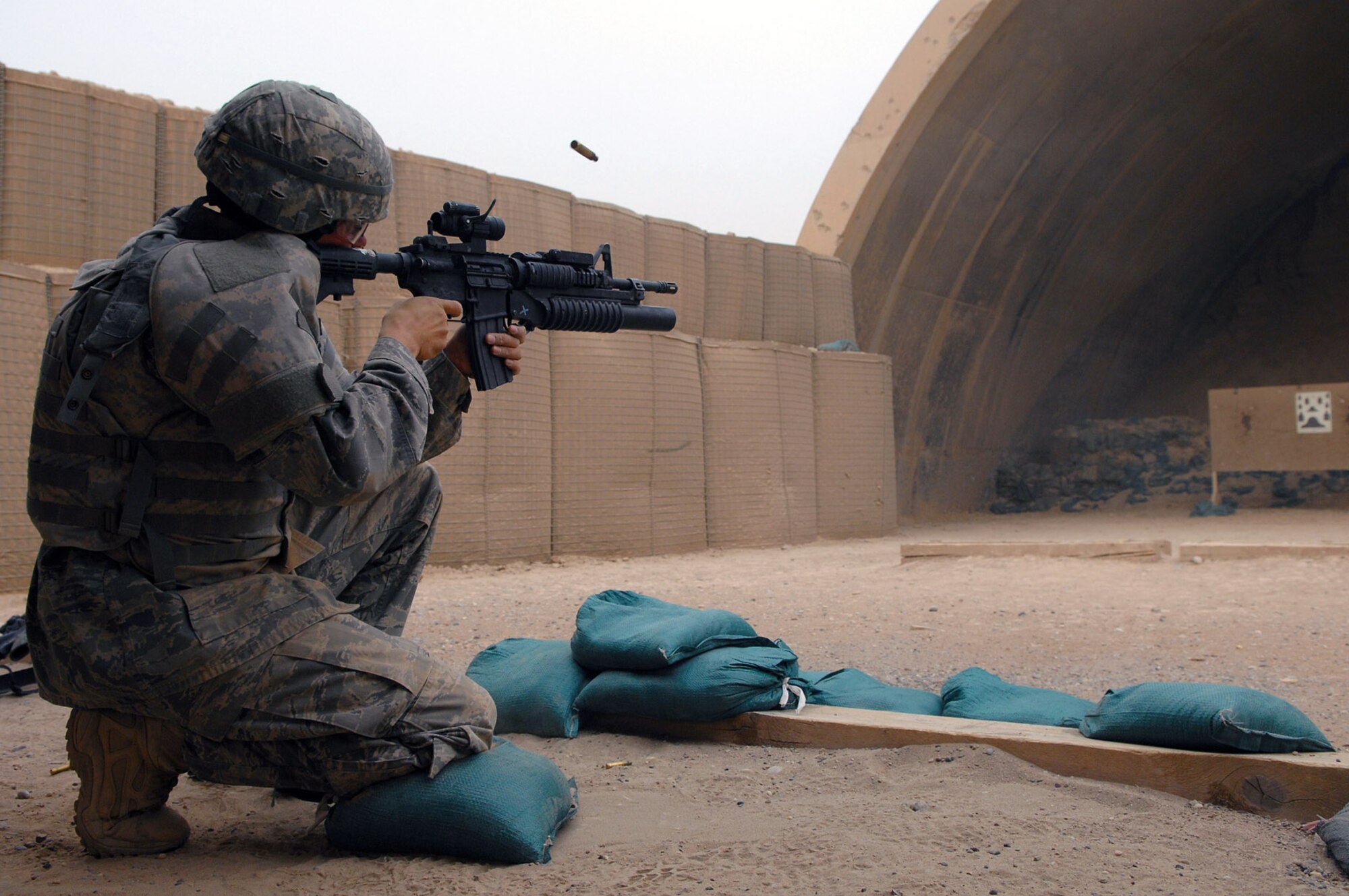 Airman 1st Class Darryl Worthey shoots an M-4 at a silhouette target that simulates various distances April 30 at Balad Air Base, Iraq. By being completely comfortable and familiar with a weapon, reaction time during an emergency situation is more timely. Airman Worthey is assigned to the 332nd Expeditionary Security Forces Squadron deployed from Mountain Home Air Force Base, Idaho. (U.S. Air Force photo/Senior Airman Julianne Showalter) 
