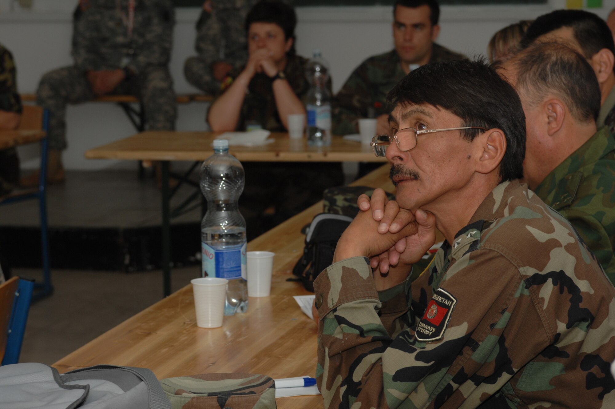 DIVULJE TRAINING BASE, Croatia – Kyrgyzstani Army Lt. Col. Alzmabek Abdyldaev listens to a Civil Affairs lecture May 6 during the 2008 Medical Training Exercise in Central and Eastern Europe (MEDCEUR).  The Civil Affairs training course is one of eleven courses offered during MEDCEUR.  Fifteen nations are participating in the exercise from May 2 through 14. The exercise focuses on mass-casualty training scenarios and humanitarian aid in response to crises situations. MEDCEUR is a Joint Chiefs of Staff regional/multilateral exercise sponsored by U.S. European Command. Croatia is hosting the 2008 exercise which has drawn about 400 multi-nationals in support of the Partnership for Peace initiative. (U.S. Air Force photo/Staff Sgt. Kristin Ruleau) 