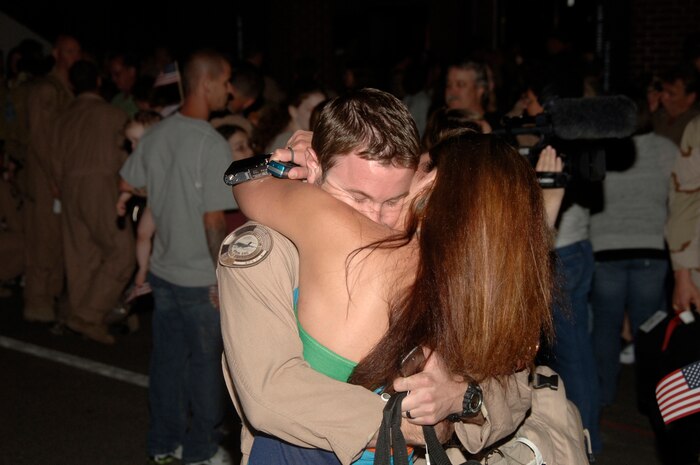 Airman 1st Class Mathew Skvarna embraces his wife,Mitzelle, after returning to Charleston AFB from a 120-day deployment May 3. Airman Skvarna is a loadmaster with the 17th Airlift Squadron. (U.S. Air Force photo/Airman 1st Class Timothy Taylor)