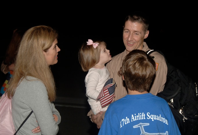 Lt. Col. Scott DeThomas greets his wife, Marta, and his two children, Brad and Anna, after returning to Charleston AFB from a 120-day deployment May 3. The 17th Airlift Squadron was part of the 816th Expeditionary Airlift Squadron in Southwest Asia for the past four months. Colonel DeThomas is the commander of the 17 AS and was the 816 EAS commander while deployed. (U.S. Air Force photo/Airman 1st Class Timothy Taylor)