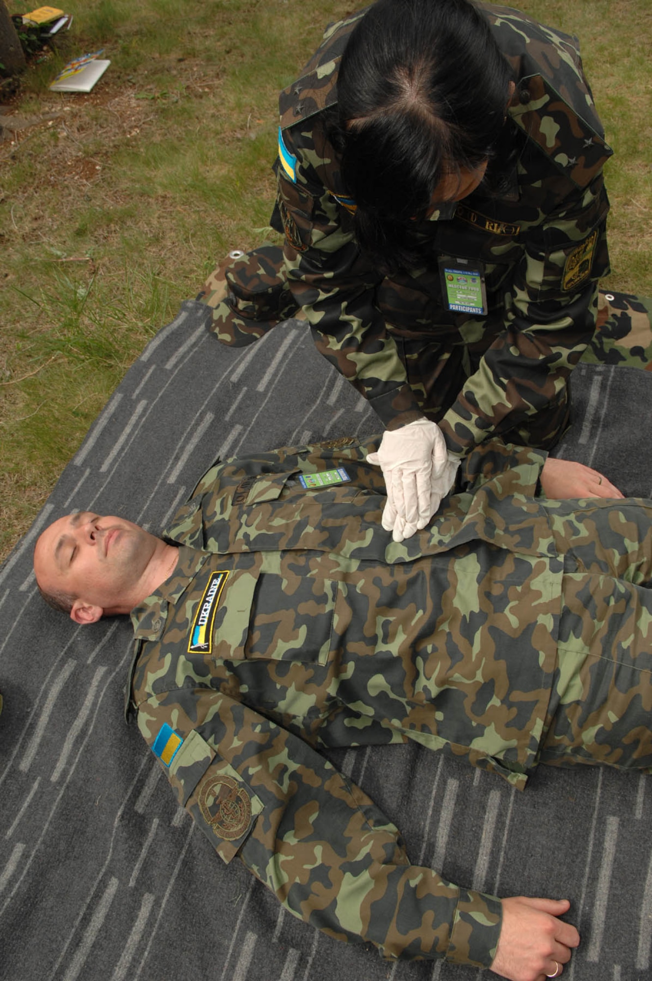 DIVULJE TRAINING BASE, Croatia – Ukrainian Army Lt. Valeria Bodyan performs a body check on Air Force Maj. Kostyantyn Humenyuk for non-visual injuries May 6 during the 2008 Medical Training Exercise in Central and Eastern Europe (MEDCEUR).  Major Humenyuk and Lt. Bodyan are two of 22 Ukranian members attending this exercise.  The Combat Life Saver (CLS) training course is one of eleven courses offered during MEDCEUR.  Fifteen nations are participating in the exercise from May 2 through 14. The exercise focuses on mass-casualty training scenarios and humanitarian aid in response to crises situations. MEDCEUR is a Joint Chiefs of Staff regional/multilateral exercise sponsored by U.S. European Command. Croatia is hosting the 2008 exercise which has drawn about 400 multi-nationals in support of the Partnership for Peace initiative. (U.S. Air Force photo/Staff Sgt. Kristin Ruleau) 