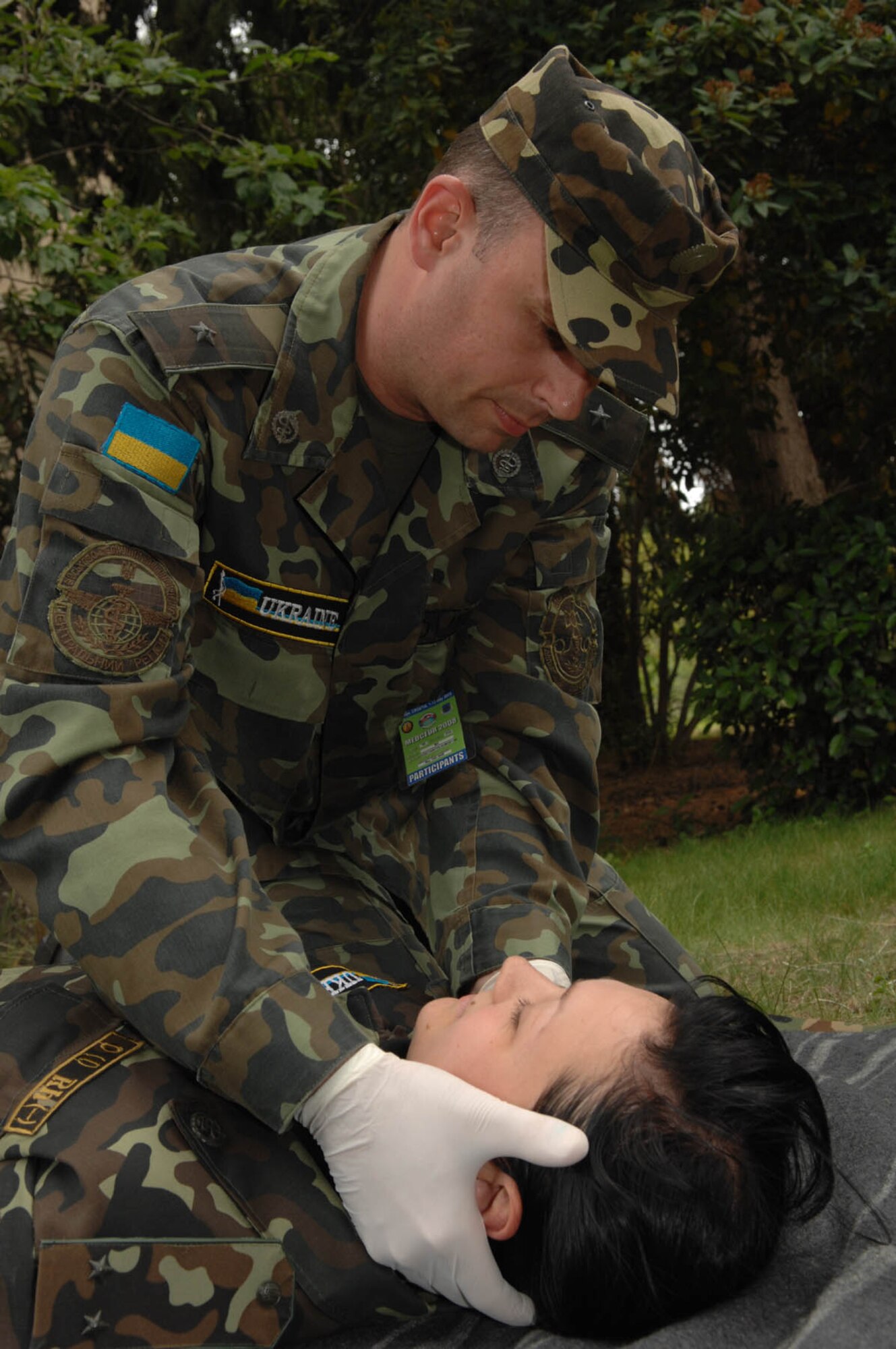 DIVULJE TRAINING BASE, Croatia – Ukrainian Air Force Maj. Kostyantyn Humenyuk performs a body check on Army Lt. Valeria Bodyan for non-visual injuries May 6 during the 2008 Medical Training Exercise in Central and Eastern Europe (MEDCEUR).  Major Humenyuk and Lt. Bodyan are two of 22 Ukranian members attending this exercise.  The Combat Life Saver (CLS) training course is one of eleven courses offered during MEDCEUR.  Fifteen nations are participating in the exercise from May 2 through 14. The exercise focuses on mass-casualty training scenarios and humanitarian aid in response to crises situations. MEDCEUR is a Joint Chiefs of Staff regional/multilateral exercise sponsored by U.S. European Command. Croatia is hosting the 2008 exercise which has drawn about 400 multi-nationals in support of the Partnership for Peace initiative. (U.S. Air Force photo/Staff Sgt. Kristin Ruleau) 