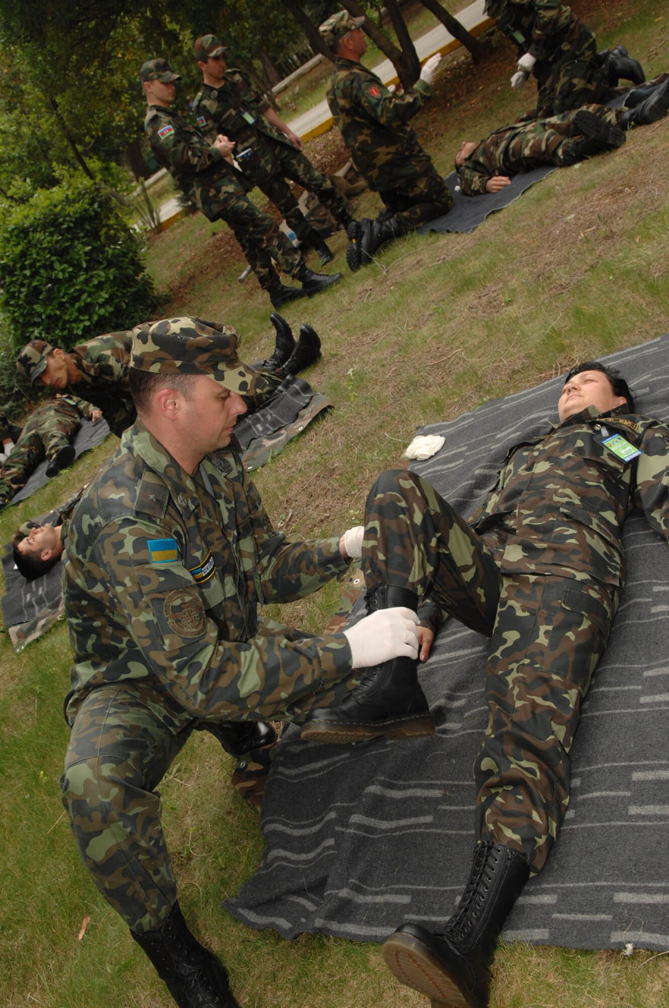 DIVULJE TRAINING BASE, Croatia – Ukrainian Air Force Maj. Kostyantyn Humenyuk performs a body check on Army Lt. Valeria Bodyan for non-visual injuries May 6 during the 2008 Medical Training Exercise in Central and Eastern Europe (MEDCEUR).  Major Humenyuk and Lt. Bodyan are two of 22 Ukranian members attending this exercise.  The Combat Life Saver (CLS) training course is one of eleven courses offered during MEDCEUR.  Fifteen nations are participating in the exercise from May 2 through 14. The exercise focuses on mass-casualty training scenarios and humanitarian aid in response to crises situations. MEDCEUR is a Joint Chiefs of Staff regional/multilateral exercise sponsored by U.S. European Command. Croatia is hosting the 2008 exercise which has drawn about 400 multi-nationals in support of the Partnership for Peace initiative. (U.S. Air Force photo/Staff Sgt. Kristin Ruleau) 
