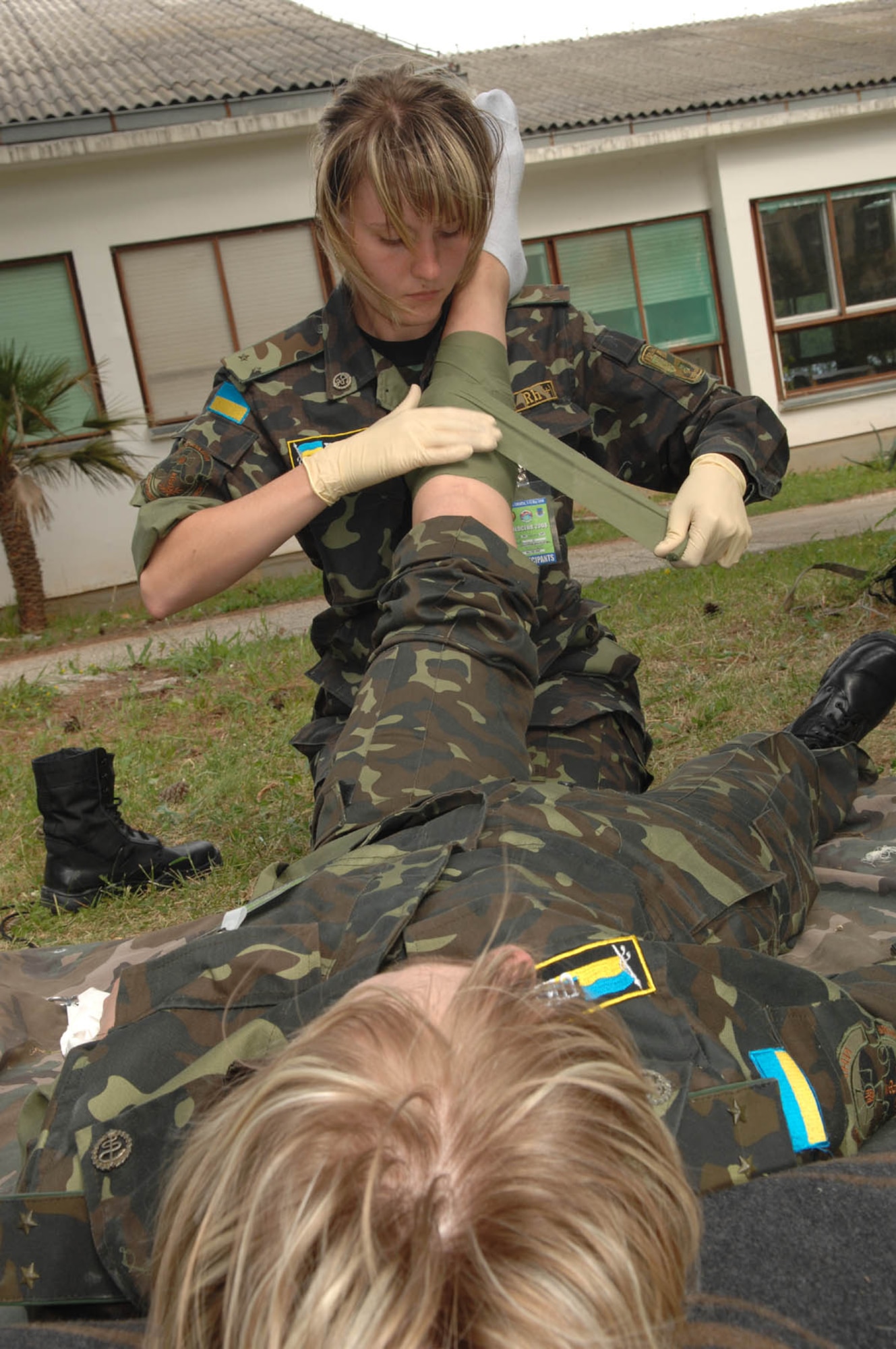 DIVULJE TRAINING BASE, Croatia – Ukrainian Army Lt. Kateryna Maruschenko practices bandaging Lt. Marina Kharitonova’s simulated injury May 6 during the 2008 Medical Training Exercise in Central and Eastern Europe (MEDCEUR).  Lieutenant’s Maruschenko and Kharitnova are two of 22 Ukranian members attending this exercise.  The Combat Life Saver (CLS) training course is one of eleven courses offered during MEDCEUR.  Fifteen nations are participating in the exercise from May 2 through 14. The exercise focuses on mass-casualty training scenarios and humanitarian aid in response to crises situations. MEDCEUR is a Joint Chiefs of Staff regional/multilateral exercise sponsored by U.S. European Command. Croatia is hosting the 2008 exercise which has drawn about 400 multi-nationals in support of the Partnership for Peace initiative. (U.S. Air Force photo/Staff Sgt. Kristin Ruleau) 