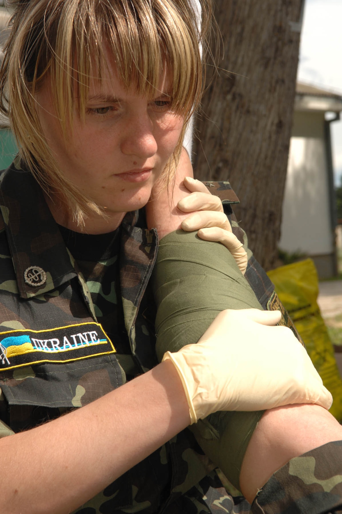 DIVULJE TRAINING BASE, Croatia – Ukrainian Army Lt. Kateryna Maruschenko practices bandaging Lt. Marina Kharitonova’s simulated injury May 6 during the 2008 Medical Training Exercise in Central and Eastern Europe (MEDCEUR).  Lieutenant’s Maruschenko and Kharitnova are two of 22 Ukranian members attending this exercise. The Combat Life Saver (CLS) training course is one of eleven courses offered during MEDCEUR.  Fifteen nations are participating in the exercise from May 2 through 14. The exercise focuses on mass-casualty training scenarios and humanitarian aid in response to crises situations. MEDCEUR is a Joint Chiefs of Staff regional/multilateral exercise sponsored by U.S. European Command. Croatia is hosting the 2008 exercise which has drawn about 400 multi-nationals in support of the Partnership for Peace initiative. (U.S. Air Force photo/Staff Sgt. Kristin Ruleau) 