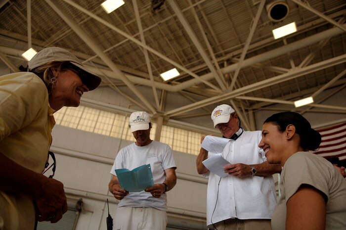 Directors rehearse a scene with Wendy Davis (right) before the filming of the Lifetime TV drama, "Army Wives," on the Charleston AFB flightline May 5. Ms. Davis plays Army Lt. Col. Joan Burton, an "Army Wives" character. (U.S. Air Force photo/Senior Airman Nicholas Pilch)