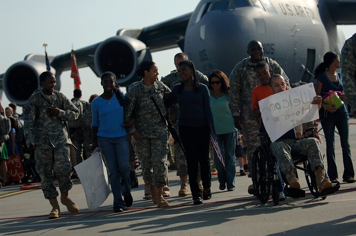 Cast members and extras celebrate with family members who have just returned from a deployment during the filming of the Lifetime TV drama, "Army Wives," on the Charleston AFB flightline May 5. Many of the extras are Airmen and family members stationed here. (U.S. Air Force photo/Senior Airman Nicholas Pilch)