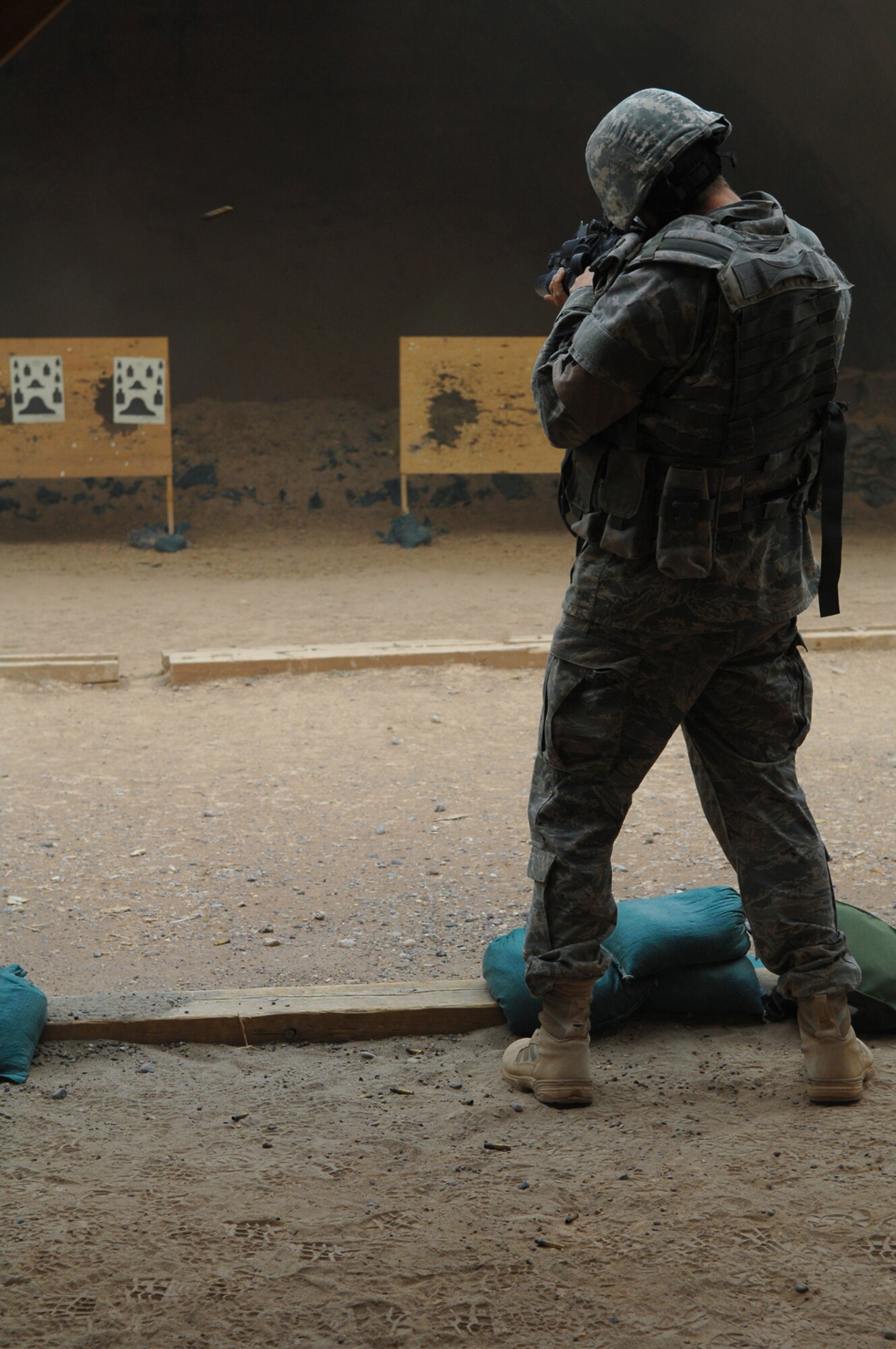 BALAD AIR BASE, Iraq -- Airman Chad McCambridge, 332nd Expeditionary Security Forces Squadron security forces, shoots an M-4 here, April 30. Security forces members went to the range to zero in their scopes and to get comfortable with their weapons. Airman McCambridge is deployed from Royal Air Force Lakenheath, United Kingdom. (U.S. Air Force photo/ Senior Airman Julianne Showalter)
