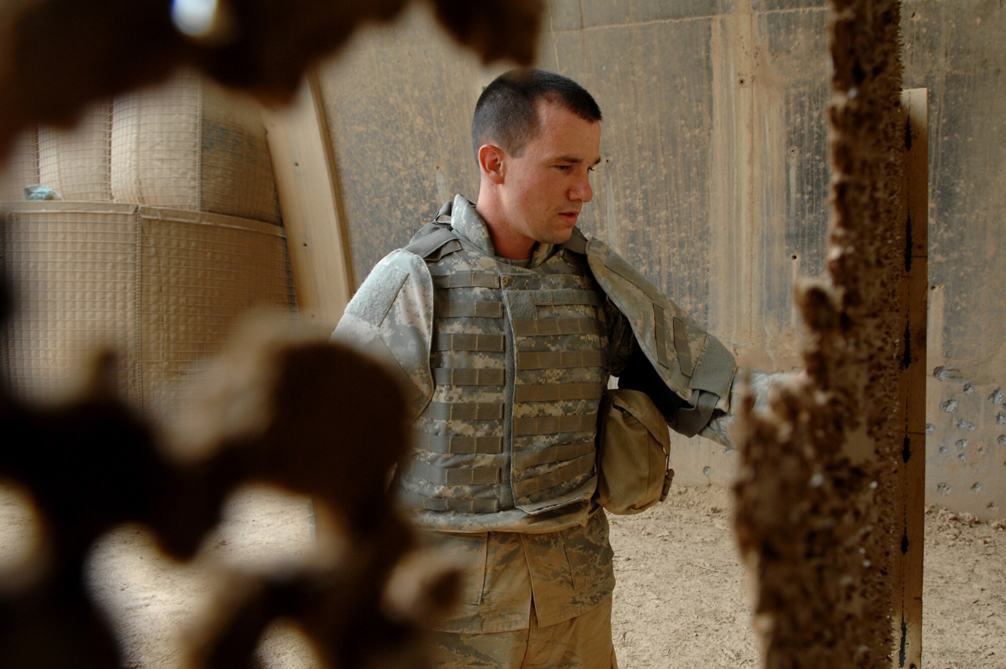 BALAD AIR BASE, Iraq -- Airman Chad McCambridge, 332nd Expeditionary Security Forces Squadron security forces, checks his silhouette target after firing 10 rounds with an M-4 here, April 30. By being completely comfortable and familiar with a weapon reaction time during an emergency situation is more timely. Airman McCambridge is deployed from Royal Air Force Lakenheath, United Kingdom. (U.S. Air Force photo/ Senior Airman Julianne Showalter)