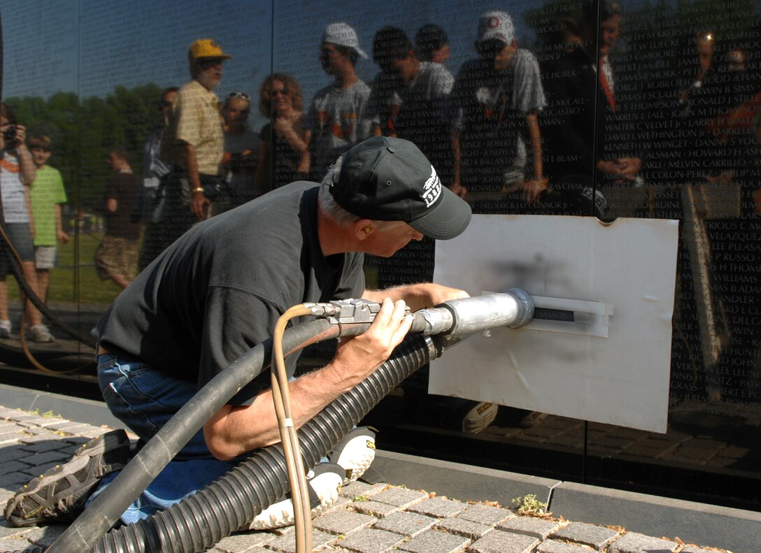 James Lee, who has engraved many names onto the Vietnam Veterans Memorial Wall, uses a sandblaster to stencil U.S. Marine Lance Cpl. Raymond C. Mason's name onto the Vietnam Veterans Memorial Wall, May 7, 2008, Washington, D.C. Mason died May 28, 2006, of complications from wounds he received Feb. 28, 1968, during the Tet Offensive.


