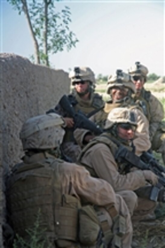U.S. Marines laugh during a lull in taking fire from insurgents during a battle in Madrassa, Afghanistan, on April 30, 2008.  The Marines are with Charlie Company, 1st Battalion, 6th Marine Regiment, 24th Marine Expeditionary Unit assigned to International Security Assistance Force.  