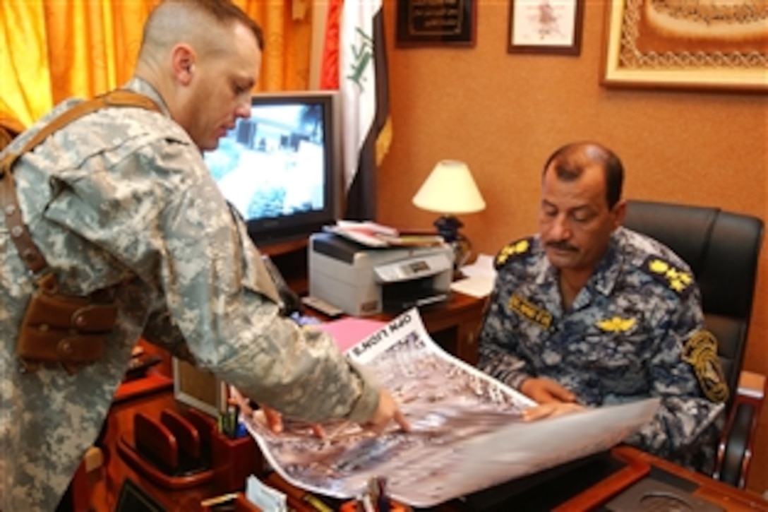 U.S. Army Lt. Col. Scott McKean discusses future operations with Iraqi Brig. Gen. Amir, responsible for the security of Baghdad al-Jidida, May 2, 2008. McKean commands seven companies of infantry, armor, engineers and combat support soldiers assigned to the 10th Mountain Division's 4th Brigade Combat Team.  