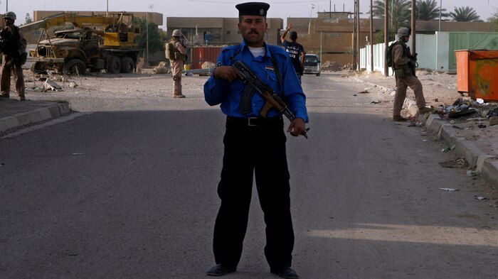 As Coalition Forces transition their security role to Iraqi Police, they conduct countless patrols at all hours through their area of operation while IPs lead from the front. The IPs are stepping up in a more prominent role which is noticeable to the people of Fallujah. More men are joining up to do their part in upholding the law and eliminating terrorism from their neighborhoods. (Official U.S. Marine Corps photo by Cpl. Chris Lyttle) (RELEASED)