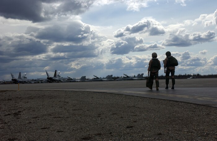 Pilots from Marine All Weather Fighter Attack Squadron 242 walk to their aircraft before a training mission in support of Northern Edge 2008 at Eielson Air Force Base in Fairbanks, Alaska. Northern Edge gives pilots the opportunity to sharpen their skills against aggressors from other services, in addition to training to respond to threats in the northern pacific theater. The squadron is based in Iwakuni, Japan.