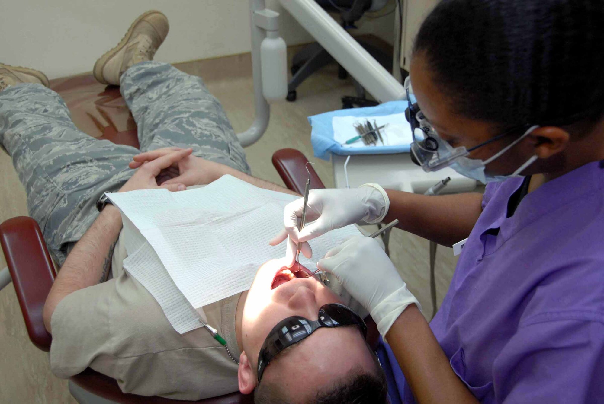 Capt. Tamara Murray, 51st Dental Squadron dentist, performs an exam on Staff Sgt. Daniel Folyar, 621st Air Control Squadron mission crew commander technician. The 51st DS ensures members of Team Osan are “Ready to Fight, Tonight” by taking care of everything from oral X-rays to ante/post mortem charting procedures and teeth cleanings. (U.S. Air Force photo/Staff Sgt. Lakisha Croley)