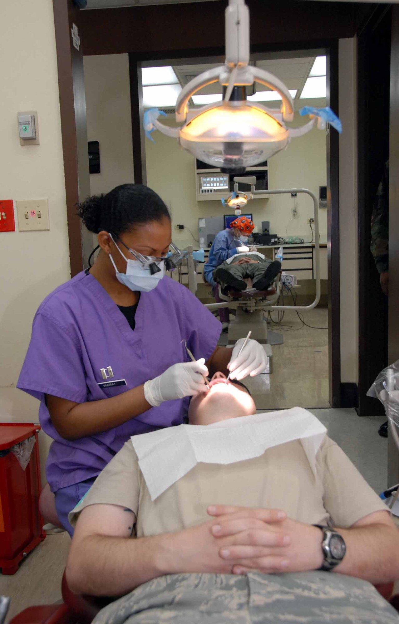 Capt. Tamara Murray, 51st Dental Squadron dentist, performs an exam on Staff Sgt. Daniel Folyar, 621st Air Control Squadron mission crew commander technician. The 51st DS ensures members of Team Osan are “Ready to Fight, Tonight” by taking care of everything from oral X-rays to ante/post mortem charting procedures and teeth cleanings. (U.S. Air Force photo/Staff Sgt. Lakisha Croley)